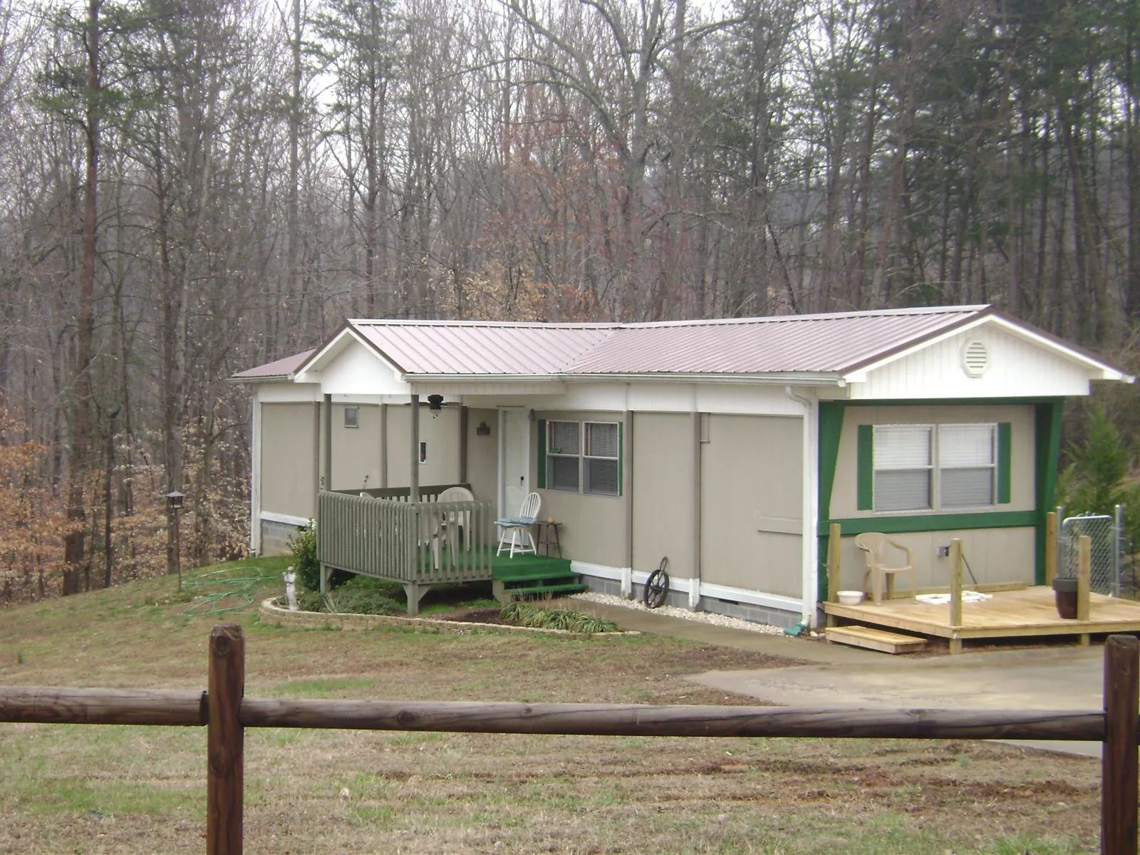 Mauve metal roof on a manufactured home with a new front deck in Hallsville